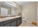 Well-lit bathroom featuring double sinks and a walk-in shower at 5910 Windsong Oak Dr, Leesburg, FL 34748