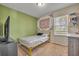 Bright bedroom featuring a bed, window for natural light and a decorative tapestry at 5910 Windsong Oak Dr, Leesburg, FL 34748
