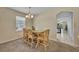 Bright dining area with stylish table, chairs, and natural light streaming through the windows at 5910 Windsong Oak Dr, Leesburg, FL 34748