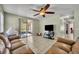 Bright living room offering access to the patio and hallway at 5910 Windsong Oak Dr, Leesburg, FL 34748