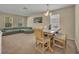 Cozy living room with dining area, neutral tones, and ample natural light at 5910 Windsong Oak Dr, Leesburg, FL 34748