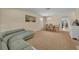 Open-concept living room featuring a modern sofa, dining area, and plenty of natural light at 5910 Windsong Oak Dr, Leesburg, FL 34748