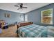 Comfortable primary bedroom showcasing a ceiling fan and wood flooring at 5910 Windsong Oak Dr, Leesburg, FL 34748