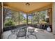 Screened-in patio with outdoor furniture and a grill, perfect for outdoor cooking at 5910 Windsong Oak Dr, Leesburg, FL 34748