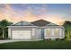 Charming single-story home with a well-manicured lawn and a two-car garage at 6032 Tree Crossing Ln, St Cloud, FL 34771