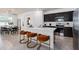 Modern kitchen featuring an island with seating, stainless steel appliances, and ample counter space at 6032 Tree Crossing Ln, St Cloud, FL 34771