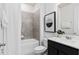 Modern bathroom with a tub, shower, sleek vanity, and stylish tile work at 6038 Tree Crossing Ln, St Cloud, FL 34771