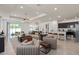 Open-concept living room with seating, dining area and modern kitchen with stainless steel appliances at 6038 Tree Crossing Ln, St Cloud, FL 34771