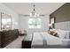 Cozy main bedroom offers a relaxing space with natural light and stylish furniture at 6038 Tree Crossing Ln, St Cloud, FL 34771