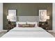 Luxurious main bedroom features a comfortable king bed and decorative lamps on bedside tables at 6038 Tree Crossing Ln, St Cloud, FL 34771