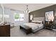 Comfortable main bedroom with a large bed, bench seating, and stylish decorations at 6038 Tree Crossing Ln, St Cloud, FL 34771