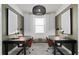 Well-lit home office space featuring matching desks, comfortable seating, and contemporary decor at 6038 Tree Crossing Ln, St Cloud, FL 34771