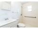 Bright bathroom featuring modern fixtures, a toilet and a shower with safety bars at 612 Kensington St, Eustis, FL 32726