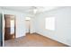 Bright bedroom with neutral carpet, a ceiling fan, and natural light from a window at 612 Kensington St, Eustis, FL 32726