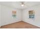 Bright bedroom featuring carpet floors, white walls, and large windows offering natural light at 612 Kensington St, Eustis, FL 32726
