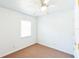 Clean bedroom featuring carpet floors, white walls, and a ceiling fan at 612 Kensington St, Eustis, FL 32726