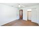 Clean bedroom featuring carpet floors, white walls, a closet and a ceiling fan at 612 Kensington St, Eustis, FL 32726