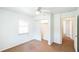 Cozy bedroom with neutral carpet, ceiling fan, closet and bright, natural light from a window at 612 Kensington St, Eustis, FL 32726