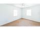 Clean bedroom featuring carpet floors, white walls, and a ceiling fan at 612 Kensington St, Eustis, FL 32726