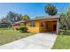 Side view of a single-story home with a connected carport at 612 Kensington St, Eustis, FL 32726
