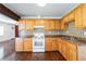 Well-lit kitchen features ample counter space and wood cabinetry at 612 Kensington St, Eustis, FL 32726