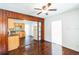 Open layout showcasing the kitchen connected to dining area with wood paneling at 612 Kensington St, Eustis, FL 32726