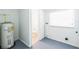 Utility room featuring a water heater, a window and laundry hookups at 612 Kensington St, Eustis, FL 32726