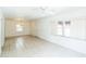 Spacious living room featuring tile flooring, a chandelier, and plenty of natural light at 612 Kensington St, Eustis, FL 32726