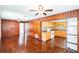 Inviting living room with wood paneling seamlessly connected to the kitchen at 612 Kensington St, Eustis, FL 32726