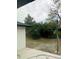 A backyard featuring grass, plants, trees and a view from a large window at 6130 Gamble Dr, Orlando, FL 32808