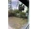 The backyard featuring lush greenery and a mix of trees, plants and a view through a large window at 6130 Gamble Dr, Orlando, FL 32808