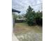 View of the backyard with a fence and a tree providing shade and privacy at 6130 Gamble Dr, Orlando, FL 32808