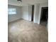 Bedroom view with closet and tiled flooring, complemented by natural light streaming through a window at 6130 Gamble Dr, Orlando, FL 32808