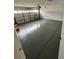 Clean, gray garage space with ladder, white brick walls and a garage door at 6130 Gamble Dr, Orlando, FL 32808