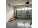 A spacious garage with a white door, offering ample space for storage and vehicle parking at 6130 Gamble Dr, Orlando, FL 32808