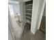 Hallway featuring shelving with access to the bathroom at 6130 Gamble Dr, Orlando, FL 32808