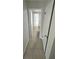 Hallway with tiled floors offers access to the bathroom and other rooms at 6130 Gamble Dr, Orlando, FL 32808