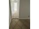 Hallway with tile flooring leading to multiple rooms at 6130 Gamble Dr, Orlando, FL 32808