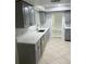 Renovated kitchen with stainless steel appliances, countertops, and gray cabinets at 6130 Gamble Dr, Orlando, FL 32808