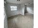 An empty living room, featuring tile floors and natural light from a window at 6130 Gamble Dr, Orlando, FL 32808