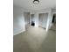 An empty living room, featuring tile floors and several doors for entering and exiting rooms at 6130 Gamble Dr, Orlando, FL 32808