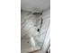 Elegant shower includes gray marble look tiling, a built-in shelf, and modern shower head at 6130 Gamble Dr, Orlando, FL 32808