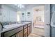 Bright bathroom features double sinks, granite countertops, decorative accents, and ensuite bedroom at 644 Hudson Valley Dr, Kissimmee, FL 34759