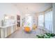 Elegant dining room with modern chandelier, decorative mirrors, and bright yellow chairs at 644 Hudson Valley Dr, Kissimmee, FL 34759