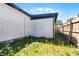 View of the side of the house with a door and a small yard area at 819 State Ave, Daytona Beach, FL 32117