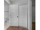 Bathroom with new wood flooring and a white door leading to the toilet and shower at 819 State Ave, Daytona Beach, FL 32117