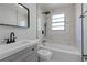 Beautifully remodeled bathroom with marble tile, a shower-tub combo, and modern fixtures at 819 State Ave, Daytona Beach, FL 32117