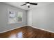 Cozy bedroom with hardwood floors, light walls, good natural light, and a ceiling fan at 819 State Ave, Daytona Beach, FL 32117