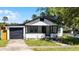 Quaint home displaying the yard, single car garage, and front porch with inviting curb appeal at 819 State Ave, Daytona Beach, FL 32117