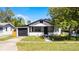 Inviting exterior showcasing a cozy single Gathering home with a well-maintained lawn and adjacent garage at 819 State Ave, Daytona Beach, FL 32117